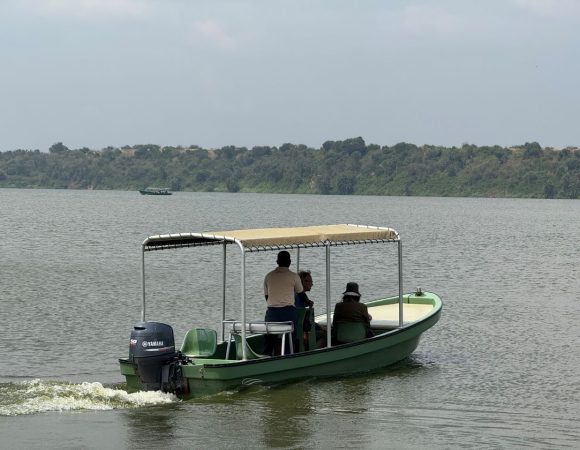 Two people on a boat with a guide