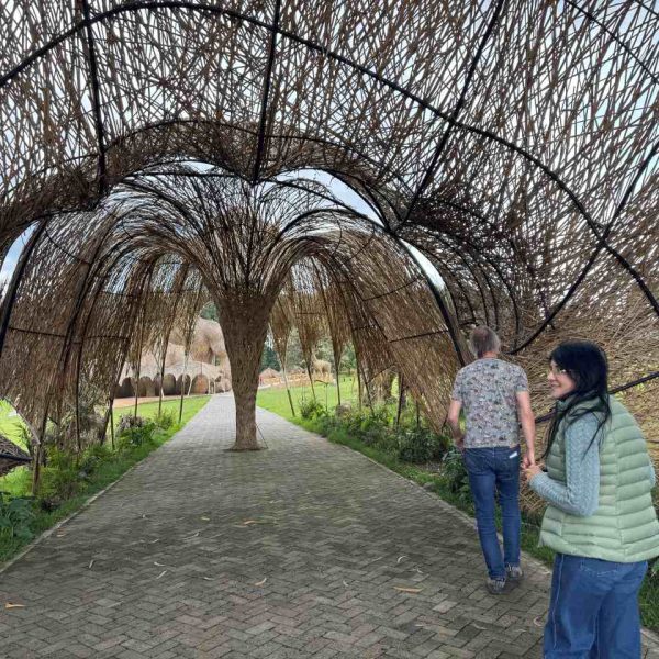 Two adults walking through a wooden walkway