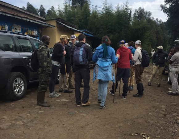 Guests receiving briefing at the foothills of Volcanoes National Park before starting their gorilla trek in Rwanda.