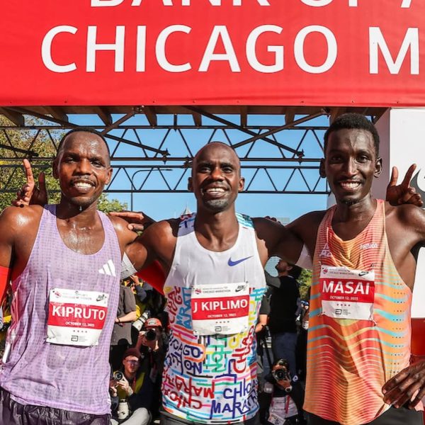 Three male runners smiling for a photo