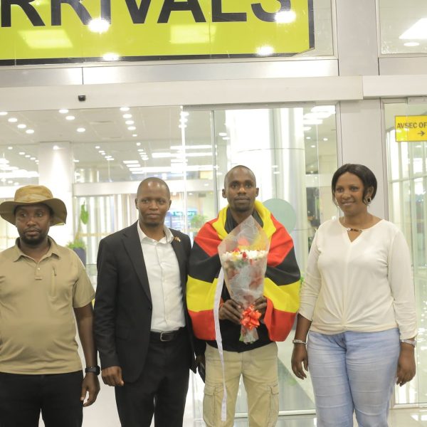Three men and one woman posing for a photo