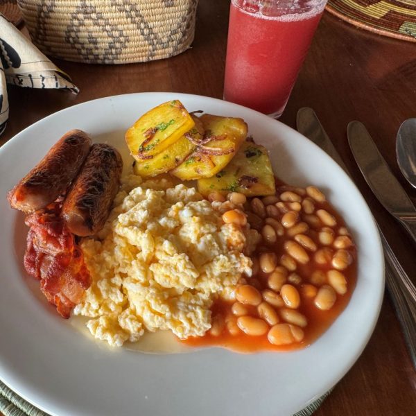 Scrambled eggs, baked beans, sausages and roast potatoes on a white plate