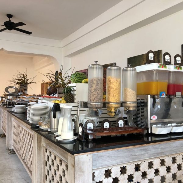 A breakfast buffet with juices and pastries 