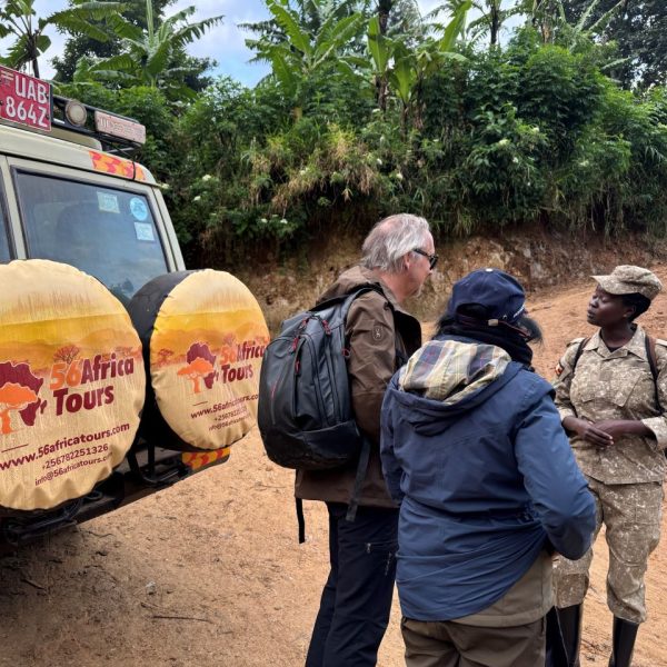 A female ranger guide briefing guests on safari
