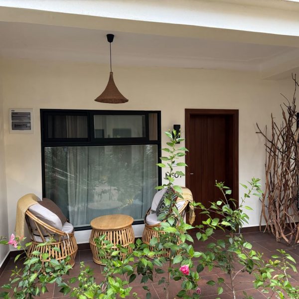 Room balcony with chairs and green flowers and plants at the edge 