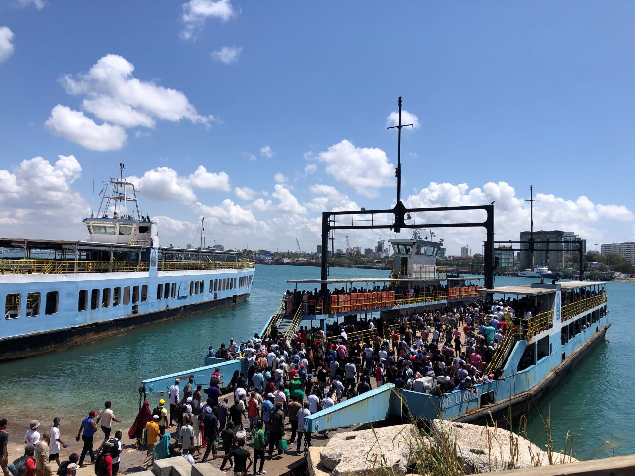 People boarding a ferry on a sunny day