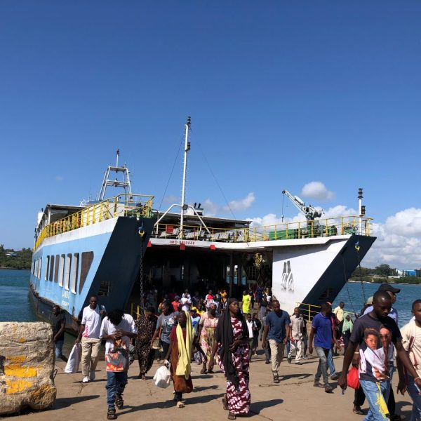 People walking out of a ferry on a sunny day