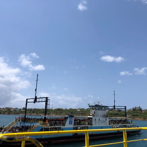 A ferry crossing on clear blue ocean waters