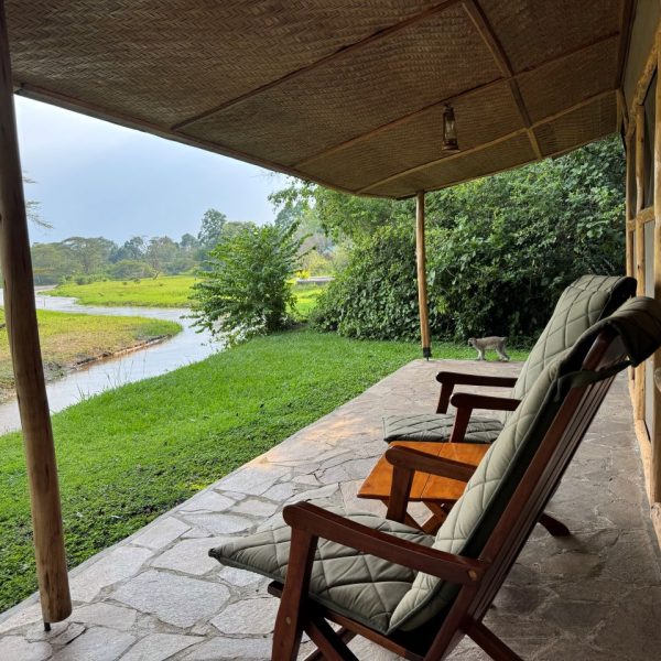 Two chairs on balcony overlooking a river