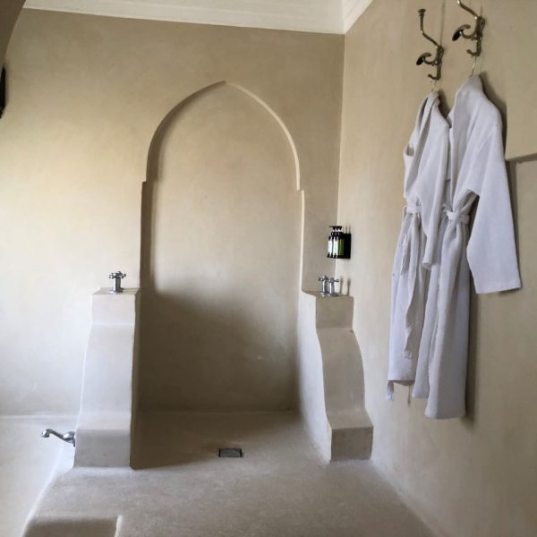 Bathrobes hung on the wall inside a bathroom