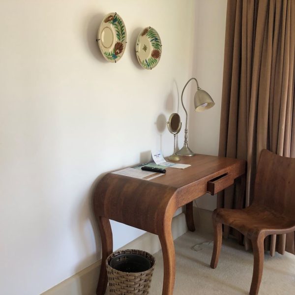 Wooden desk, wooden chair and plate wall hangings 