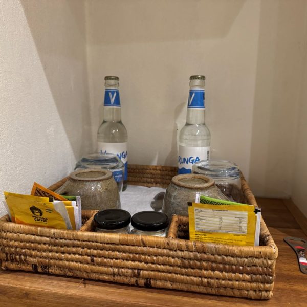 Tea station with different tea types and water in glass bottles 