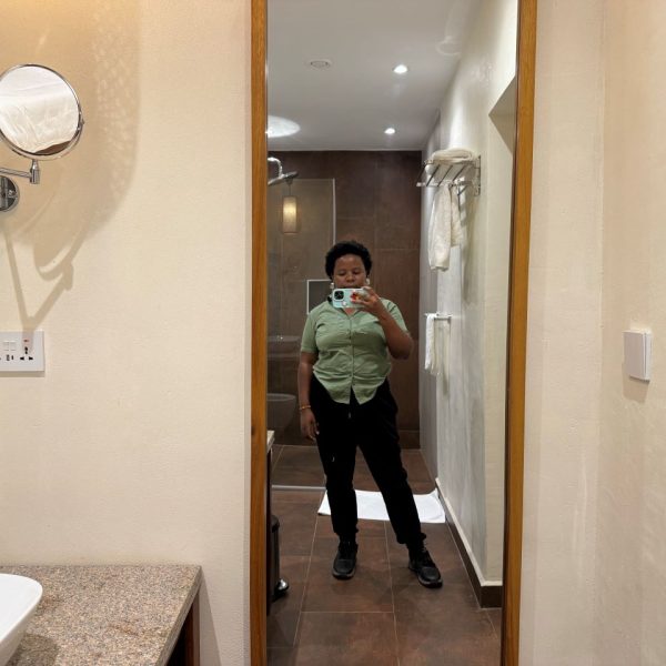 A woman standing in front of a mirror