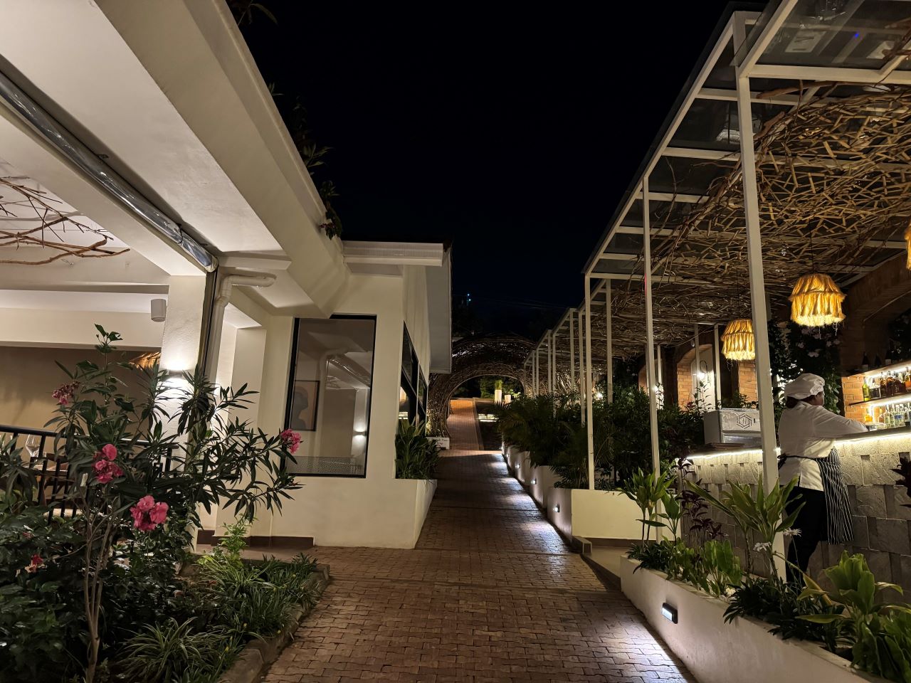 A walkway with a well-lit area in the evening
