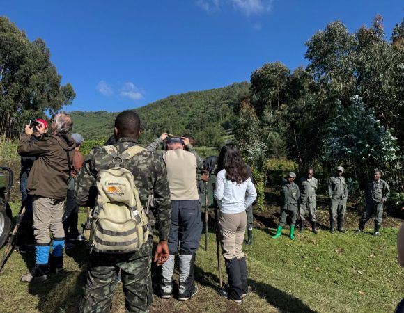 Tourists standing near rangers and porters before a gorilla trek