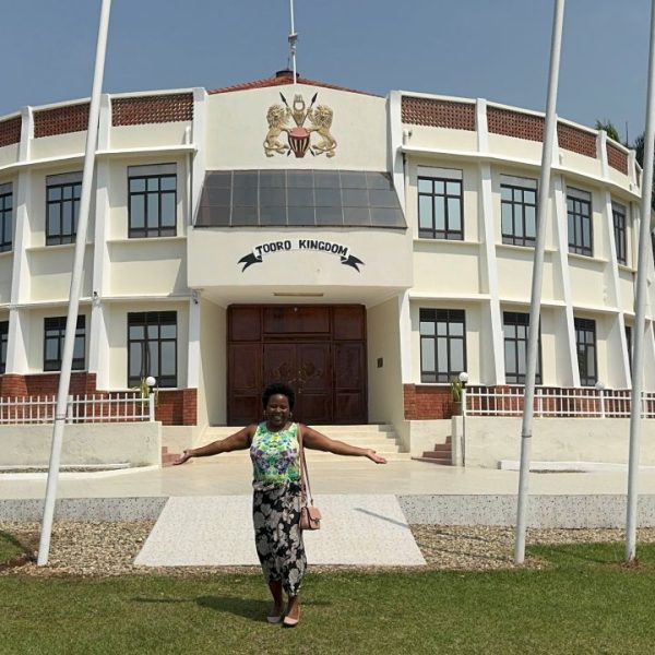 A woman standing in front of a large white building