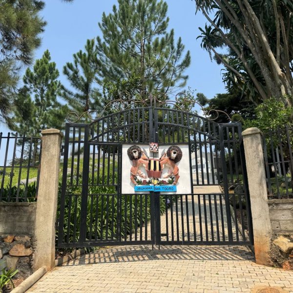 A black gate with a coat of arms